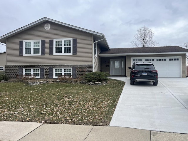 split level home featuring a garage and a front lawn