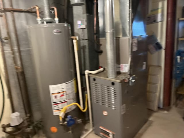 utility room with gas water heater and heating unit