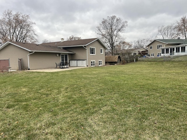 rear view of house featuring a patio area and a yard