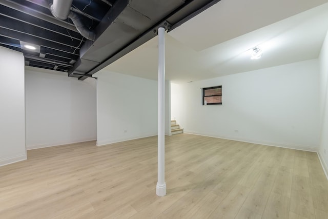 basement with light hardwood / wood-style floors