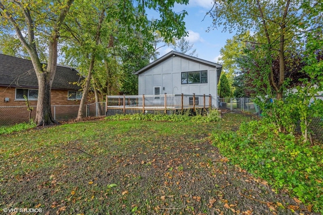 rear view of house with a wooden deck