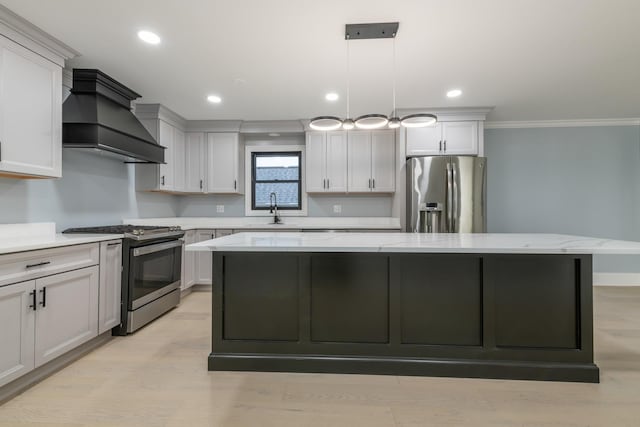 kitchen with light stone countertops, hanging light fixtures, stainless steel appliances, a kitchen island, and ornamental molding