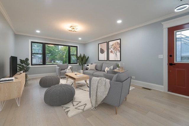 living room featuring crown molding and light wood-type flooring