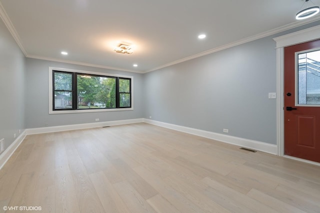 empty room with light wood-type flooring and ornamental molding