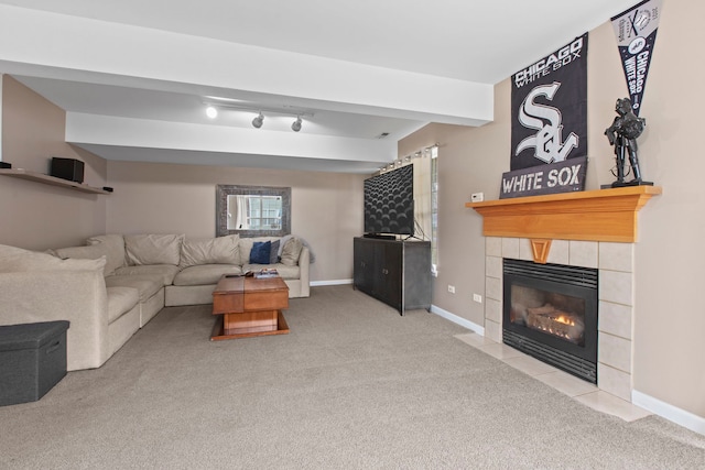 living room with a tile fireplace and light colored carpet