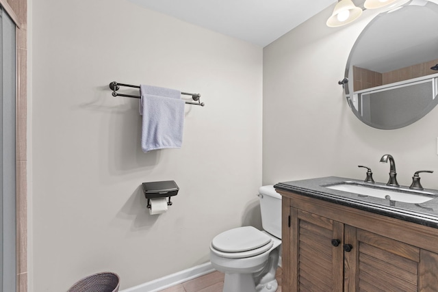 bathroom with tile patterned floors, vanity, toilet, and walk in shower