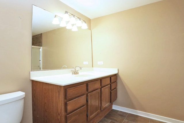 bathroom featuring vanity, toilet, and an enclosed shower