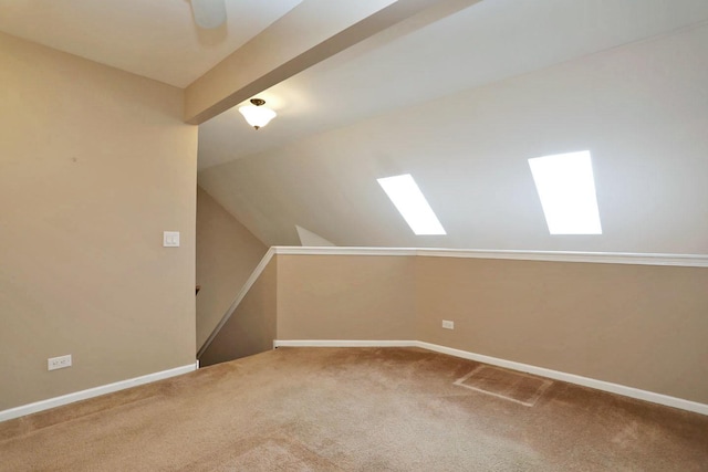 additional living space featuring carpet and lofted ceiling with beams