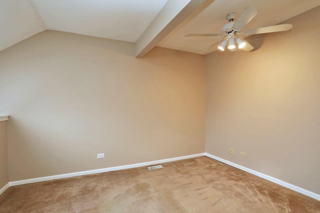 carpeted spare room featuring ceiling fan and vaulted ceiling