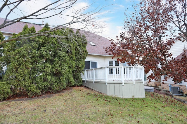 view of home's exterior featuring a yard, a wooden deck, and central AC