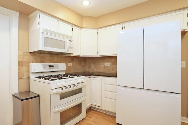 kitchen featuring white cabinetry, light wood-type flooring, and white appliances