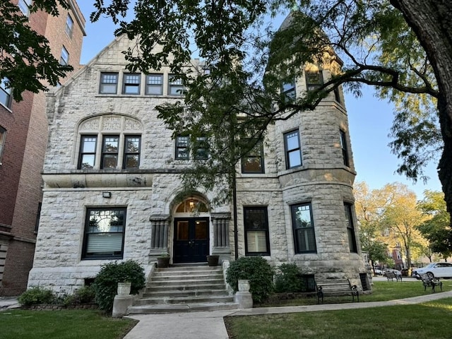 view of front of house featuring a front lawn and french doors