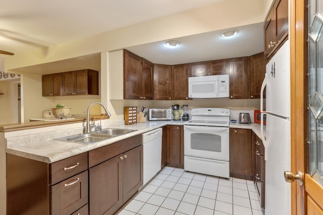 kitchen featuring kitchen peninsula, sink, light tile patterned flooring, and white appliances