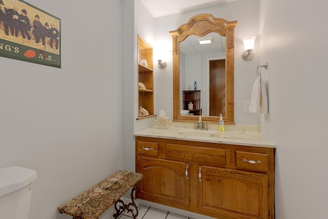 bathroom featuring toilet, vanity, and tile patterned floors