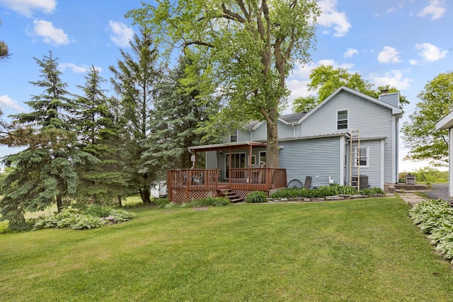 back of house with a lawn and a wooden deck