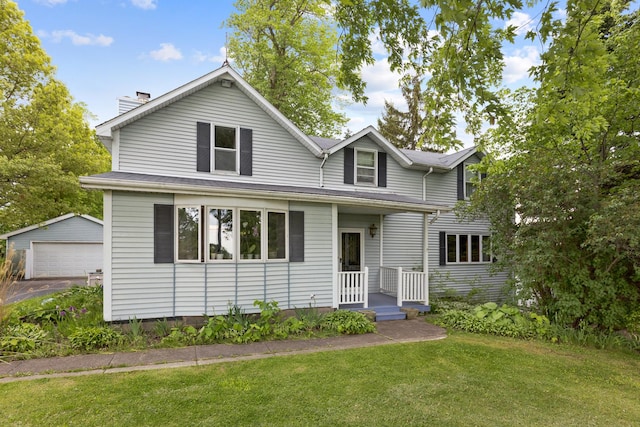 view of property with a front lawn, an outdoor structure, and a garage