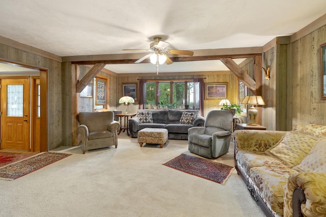 living room featuring carpet, ceiling fan, and wood walls