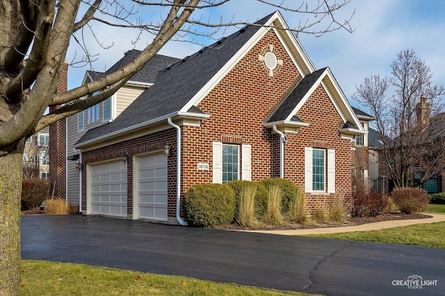 view of side of home with a garage