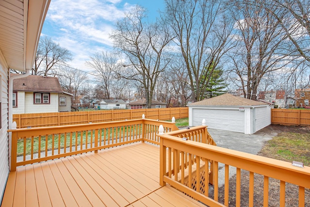 wooden terrace with an outdoor structure and a garage