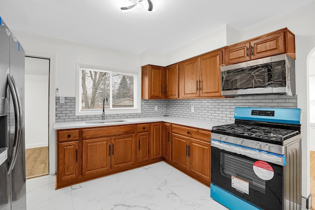 kitchen with stainless steel appliances, tasteful backsplash, and sink