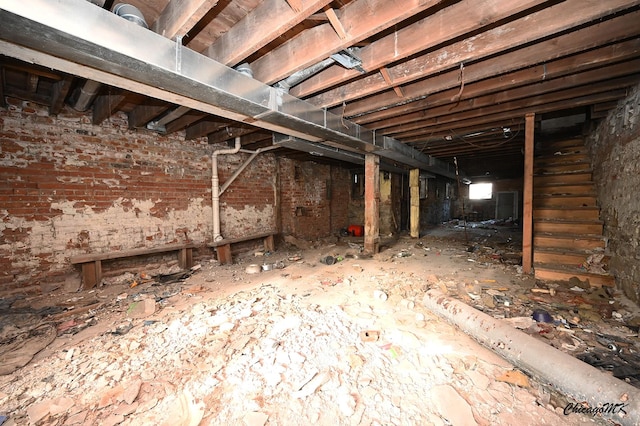 basement with brick wall