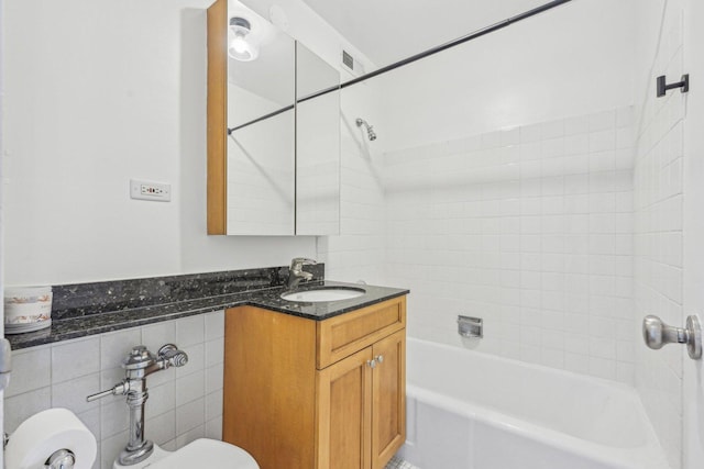 full bathroom with vanity, toilet, and tiled shower / bath combo