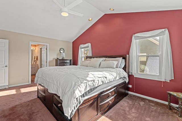 carpeted bedroom with ceiling fan, ensuite bathroom, and vaulted ceiling