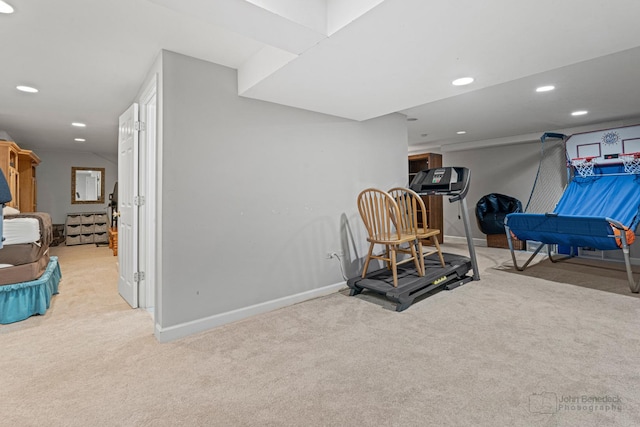 exercise room featuring light carpet