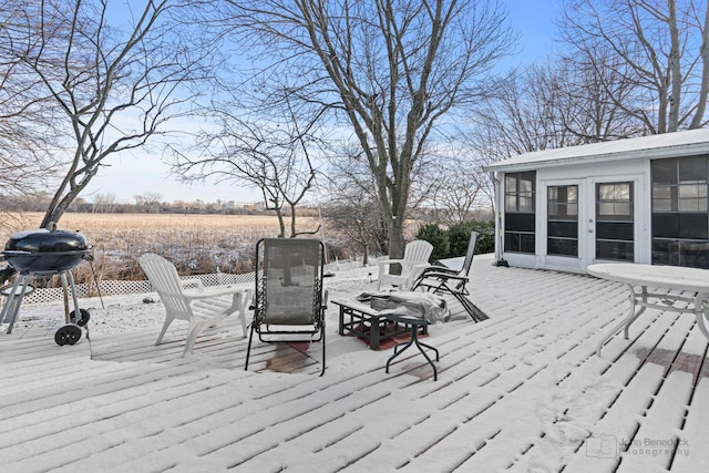 wooden deck with a grill and a sunroom