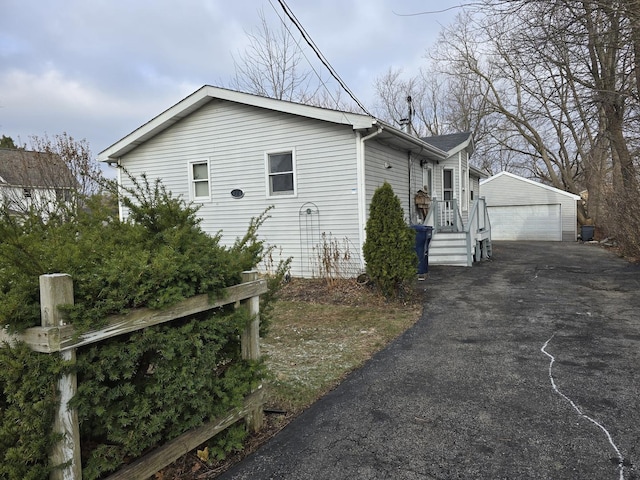 view of property exterior featuring a garage and an outdoor structure