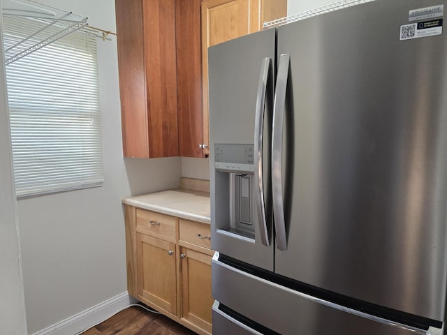 kitchen with dark hardwood / wood-style floors and stainless steel fridge with ice dispenser