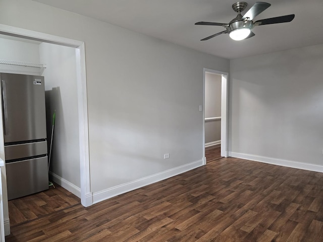 spare room featuring ceiling fan and dark wood-type flooring