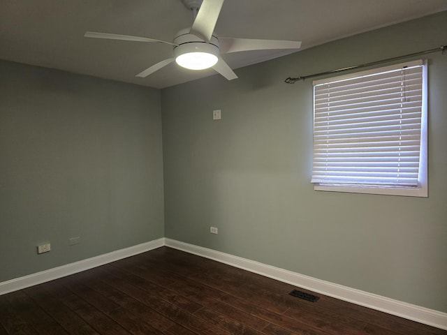 empty room with ceiling fan and dark hardwood / wood-style flooring