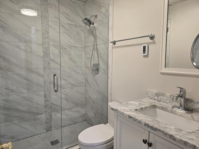 bathroom featuring toilet, vanity, and walk in shower