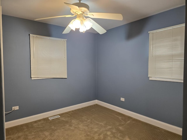 empty room featuring carpet flooring and ceiling fan