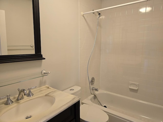 full bathroom featuring toilet, vanity, and tiled shower / bath