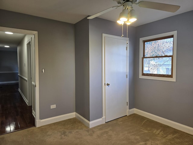 carpeted empty room featuring ceiling fan