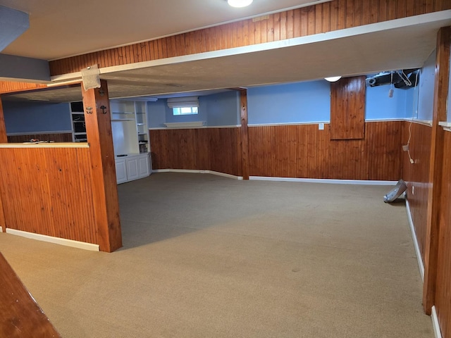 basement with carpet and wooden walls