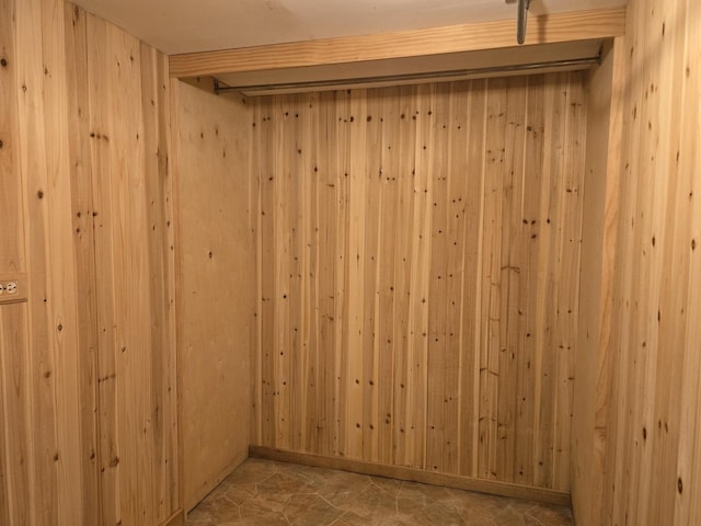 unfurnished room with wood walls