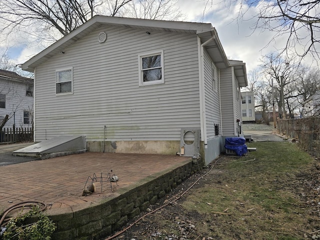 view of property exterior with a patio area