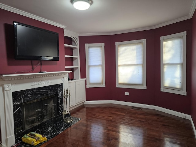 unfurnished living room featuring a high end fireplace, ornamental molding, built in features, and dark wood-type flooring