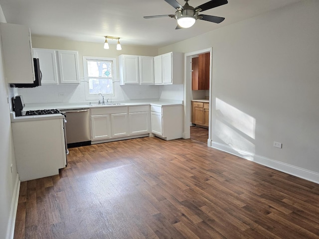 kitchen with white cabinets, stainless steel dishwasher, sink, and hardwood / wood-style floors