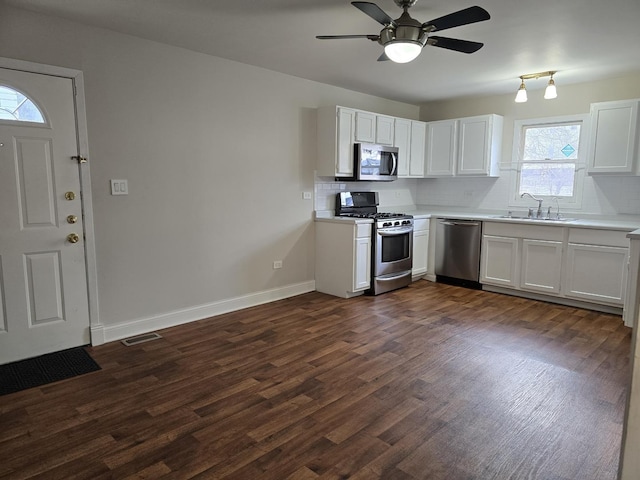 kitchen with white cabinets, stainless steel appliances, a wealth of natural light, and sink