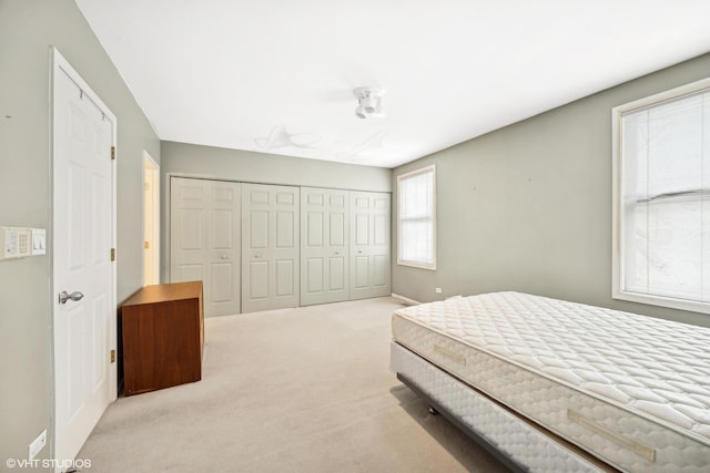 carpeted bedroom with a closet