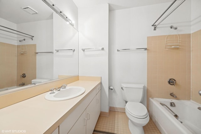 full bathroom featuring tiled shower / bath combo, toilet, and vanity