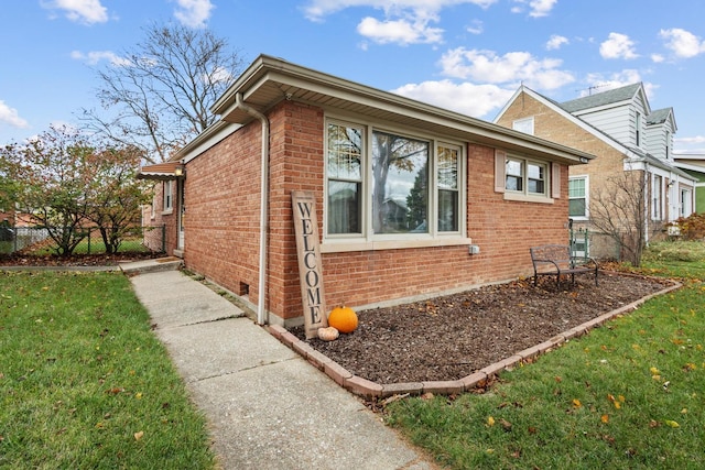 view of side of property with a yard