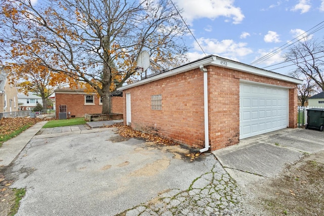 view of home's exterior with a garage and an outbuilding