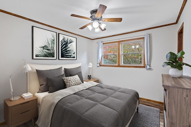 bedroom featuring hardwood / wood-style flooring, ceiling fan, and crown molding