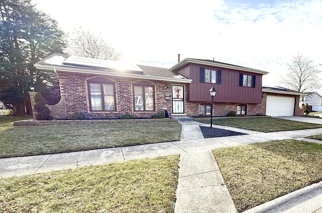 tri-level home with a front yard and a garage