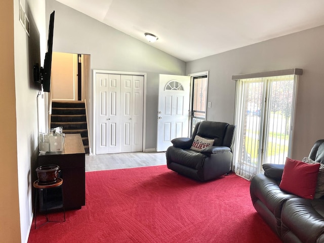 living room featuring hardwood / wood-style floors and lofted ceiling